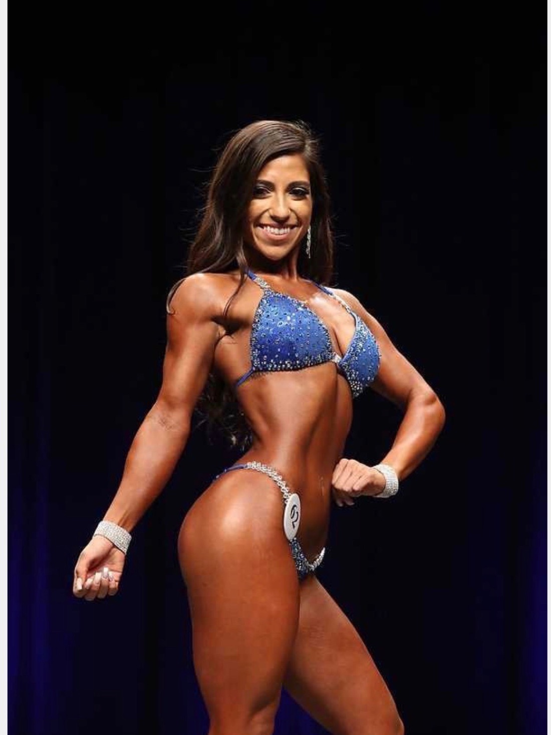 May on stage at an NPC Bikini competition.